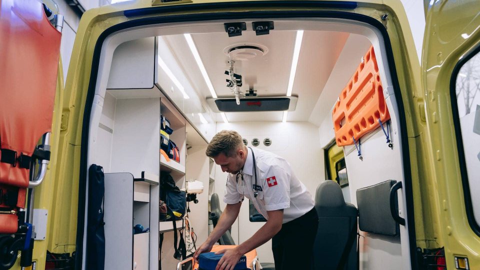 An ambulance with a man in the back of it.